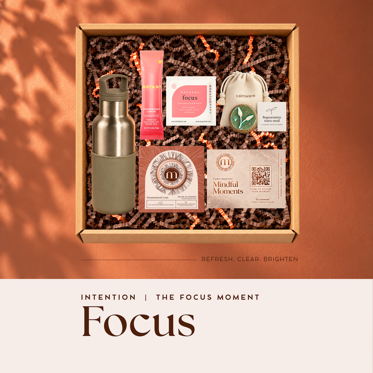 Focus Intention engagement kit with insulated bottle, electrolyte stick, Calmware grounding stone, Breatherapy aromatherapy patch, Baume du Moment and Mindful Moments card in a gift box