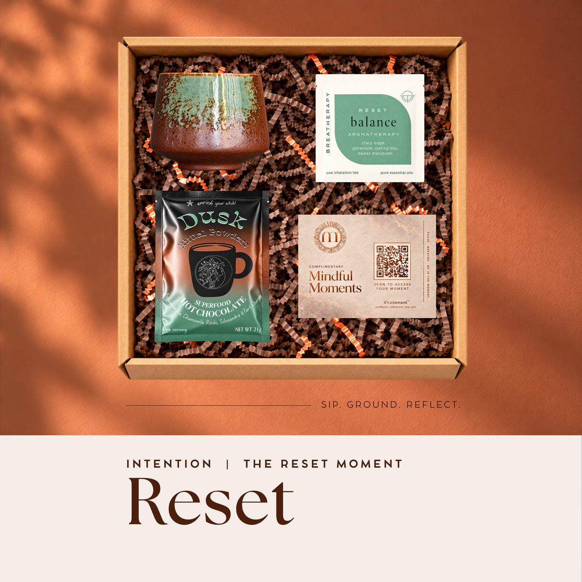Reset Intention engagement kit with hand-glazed ceramic mug, Dusk reishi hot chocolate, Breatherapy aromatherapy patch and Mindful Moments card in a gift box