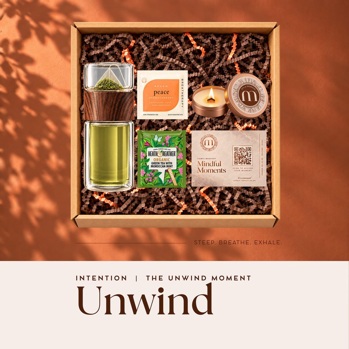 Unwind Intention engagement kit with glass tea infuser bottle, Heath and Heather mint green tea, signature candle, Breatherapy patch and Mindful Moments card in a gift box