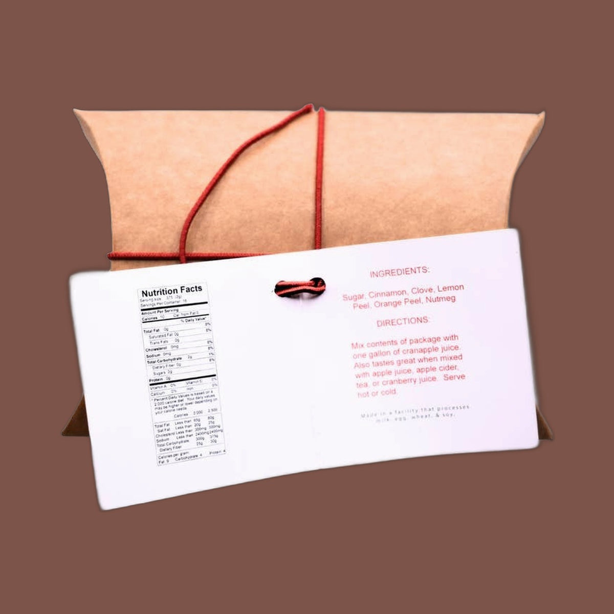 Mills Gourmet Mulling Spice in a kraft pillow box tied with red string, view 3