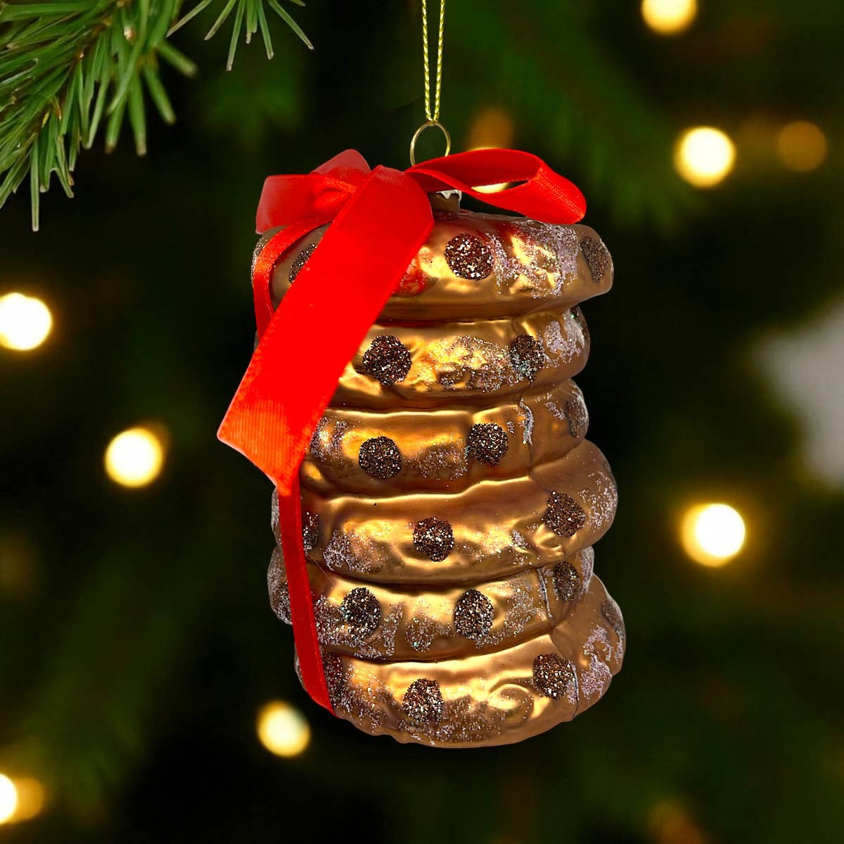 Glass ornament shaped like a stack of chocolate chip cookies tied with a red bow, view 3